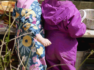 Two small children playing beside a bench
